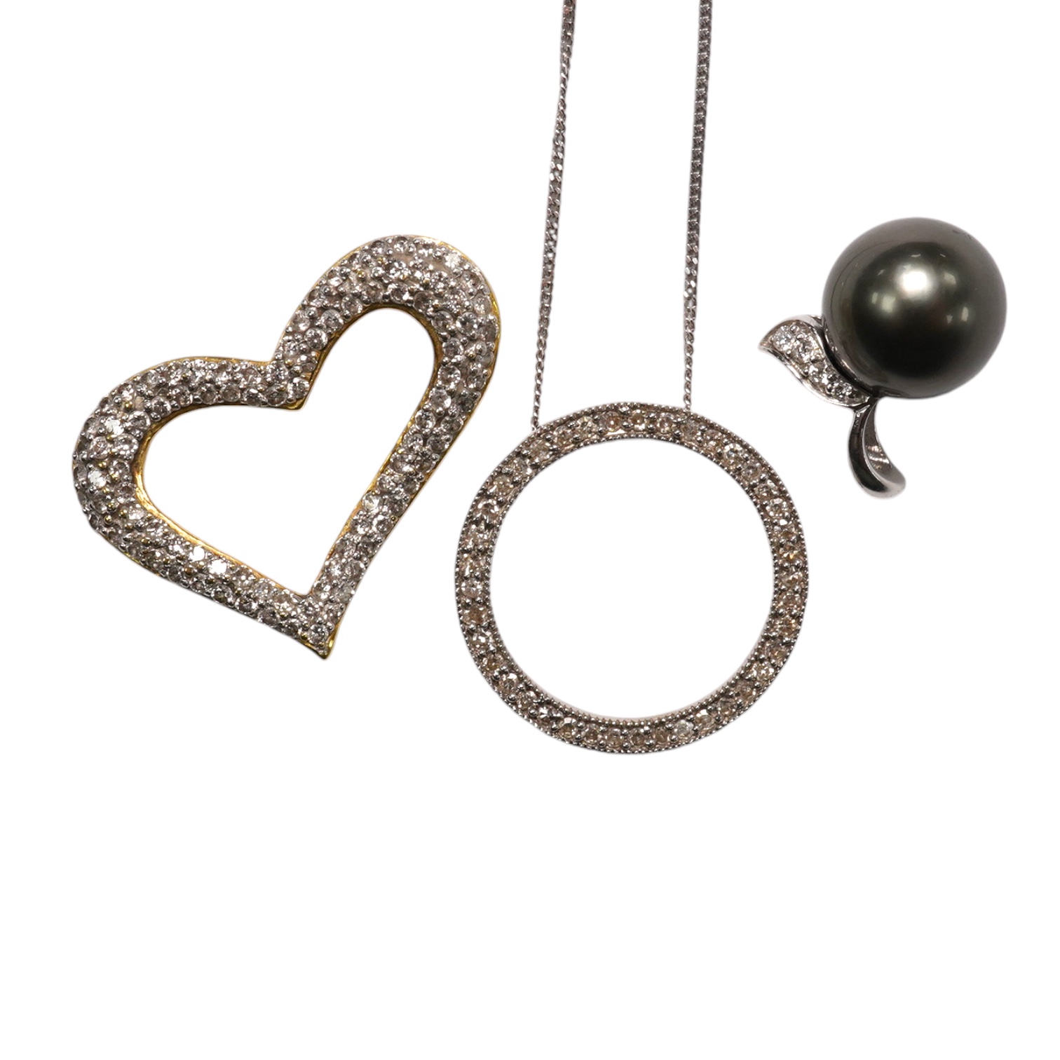 A modern 18k and diamond cluster set open work heart pendant, 25mm, a 9ct white gold and diamond chip set circular pendant necklace and o 9ct and Tahitian cultured pearl set pendant. Condition - fair to good